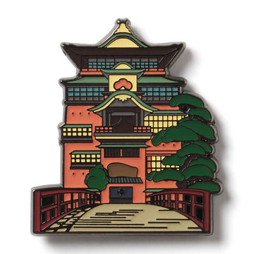 Enamel pin with a design of a traditional Japanese building and tree on a white background. Onsen Bathhouse from Studio Ghibli's Spirited Away enamel lapel pin for the Academy Museum